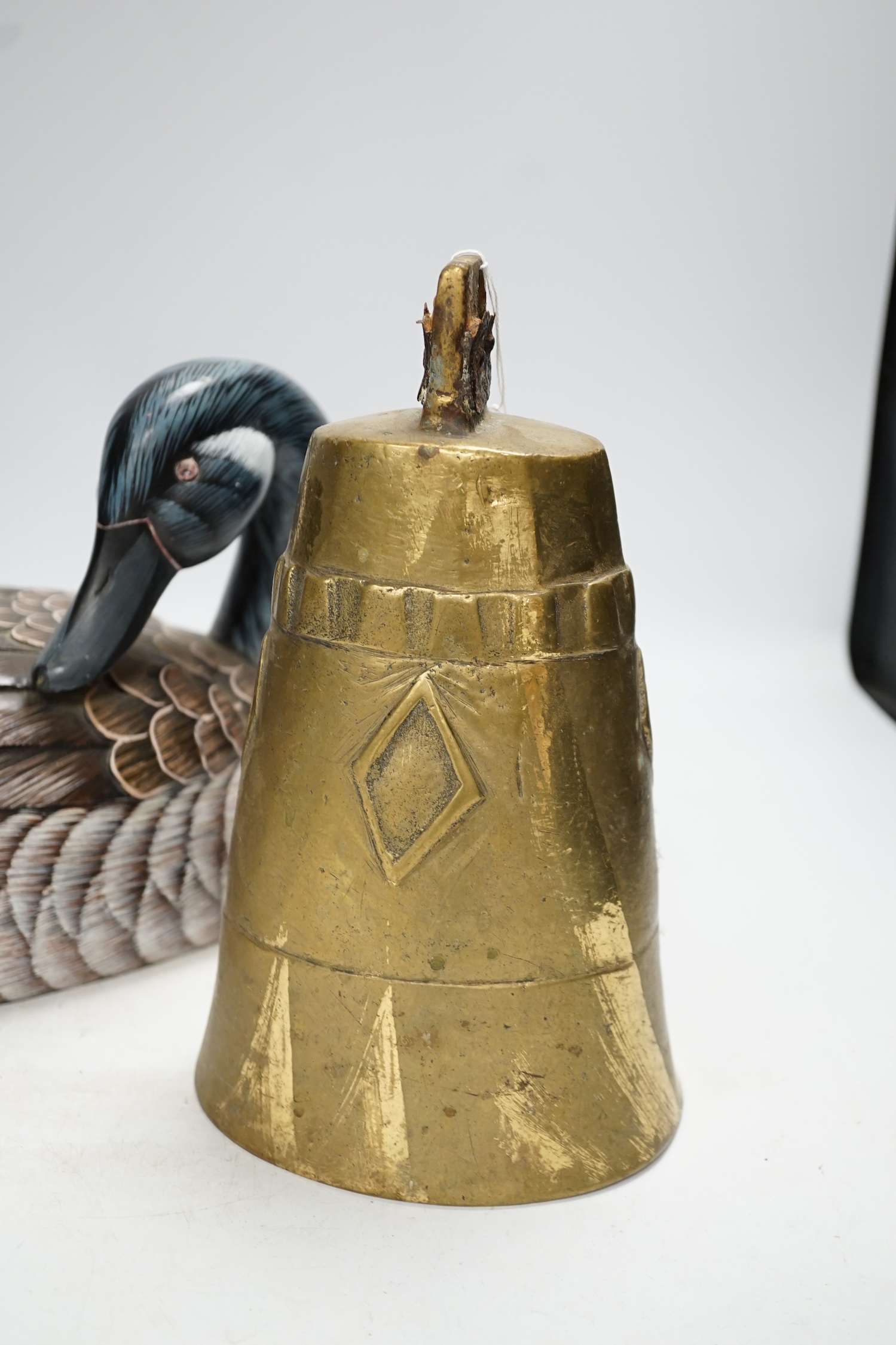 A Chinese carved wood duck and a brass bell, bell 25cm high. Condition - fair